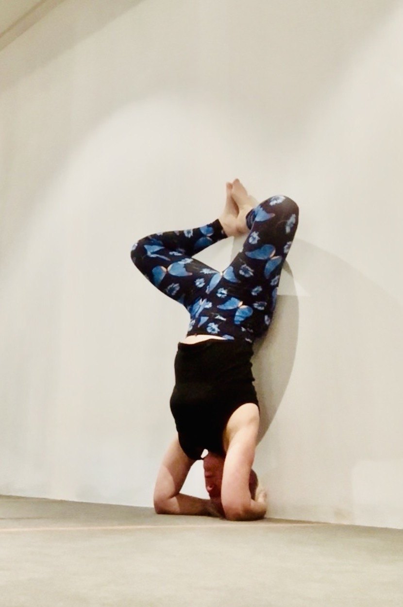 Mel playfully practising a supported headstand