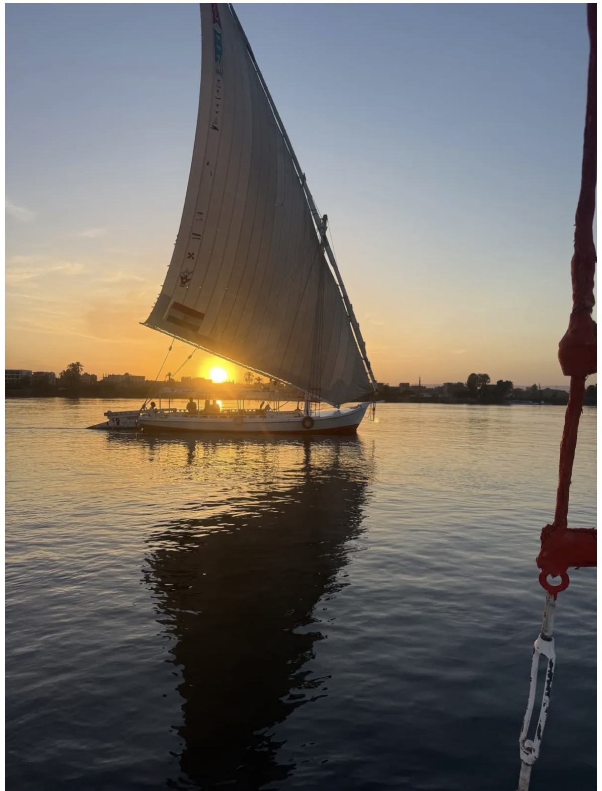 A felucca sailing on the Nile at sunset