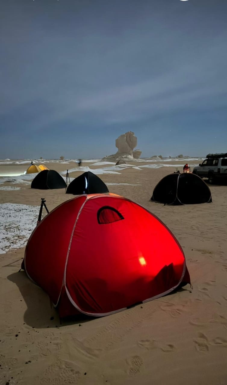 Red tent glowing at night in a White Desert camp