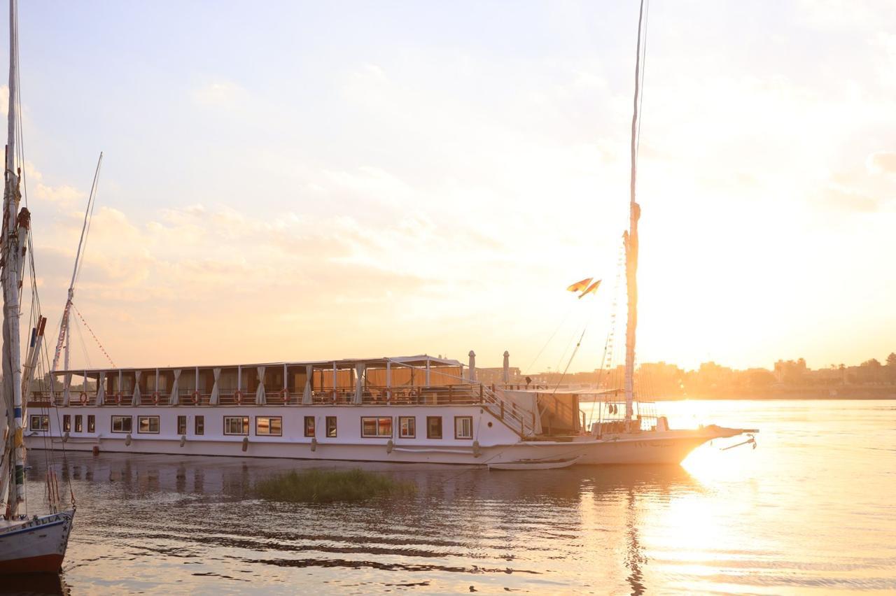 A dahabiya resting on the Nile in golden sunset light