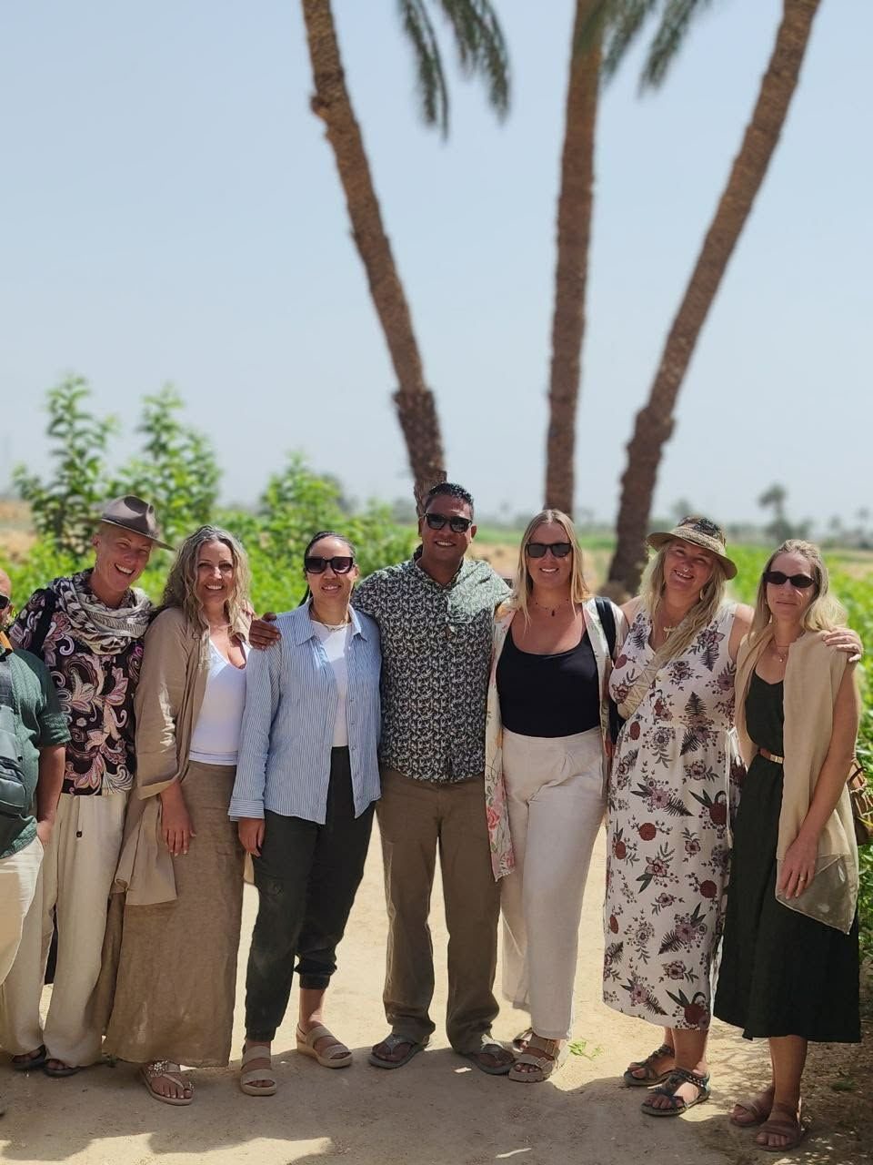 Travelling companions gathered beneath the palms in Egypt