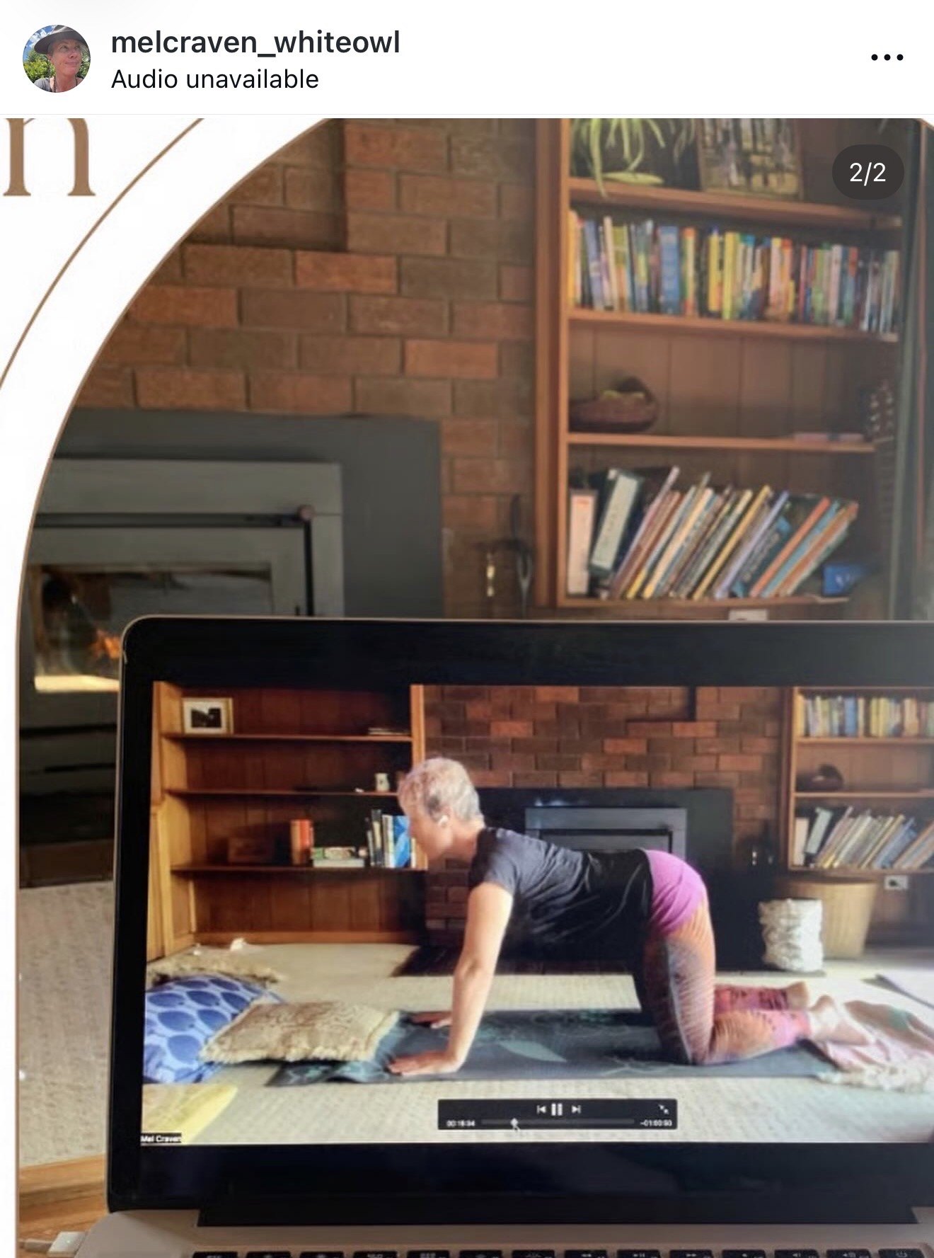 A recorded online yoga class with Mel playing on a laptop